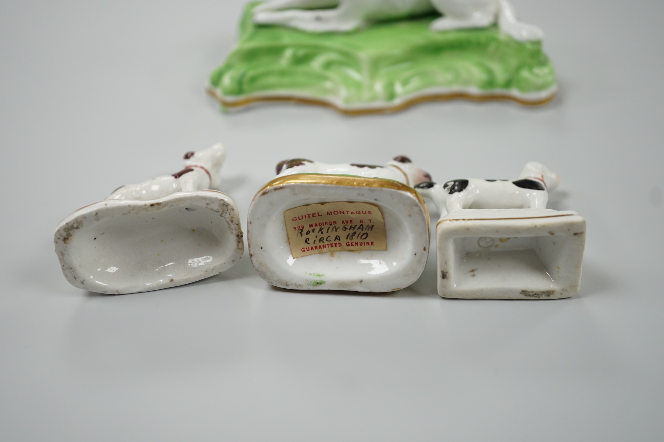 Three toy Staffordshire models of standing terriers; two with brown spots and the other black spots, together with a small Staffordshire model of a recumbent black and white setter on modelled base. c.1830-50, Largest 13